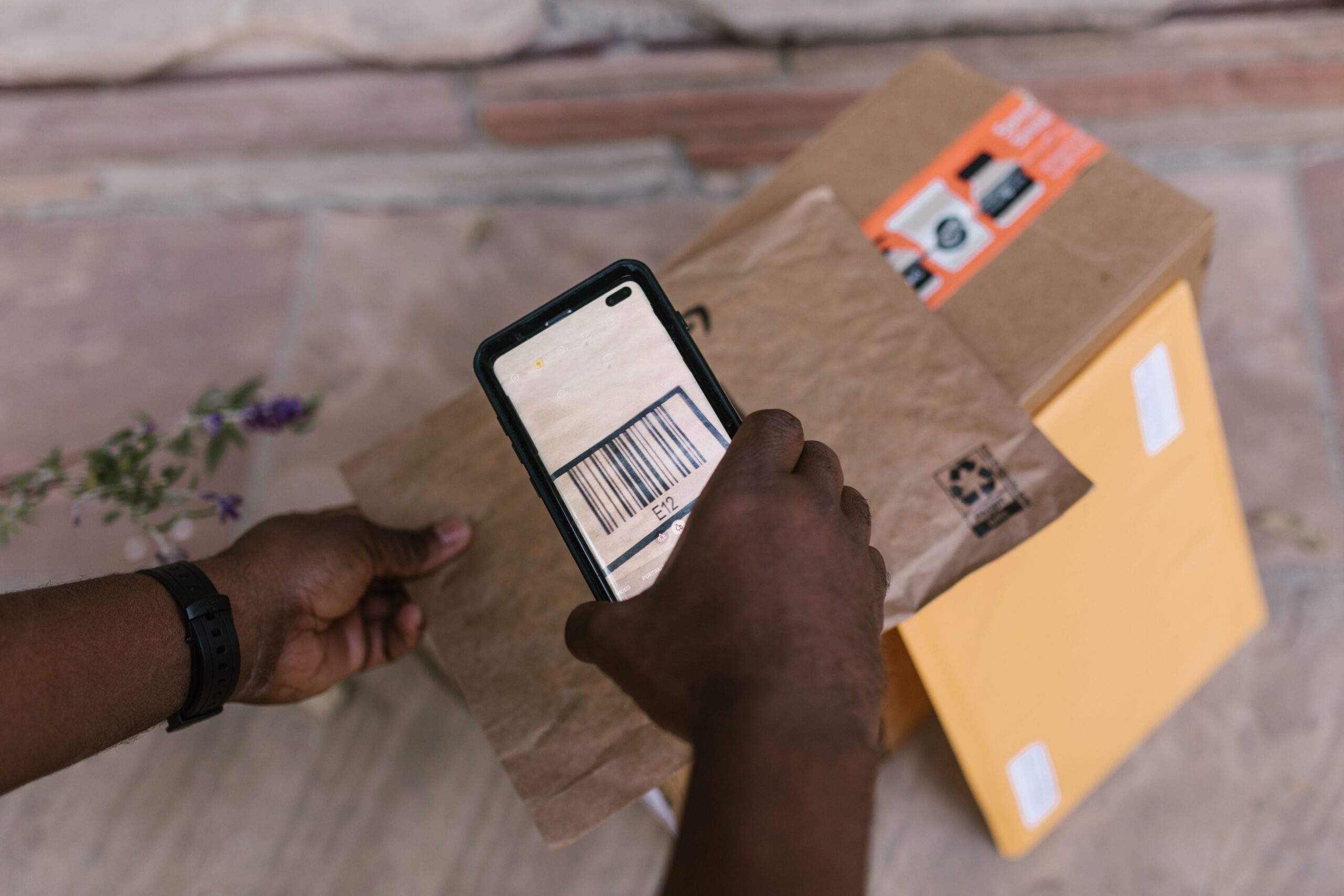 Courier scanning a parcel barcode at carrier handover
