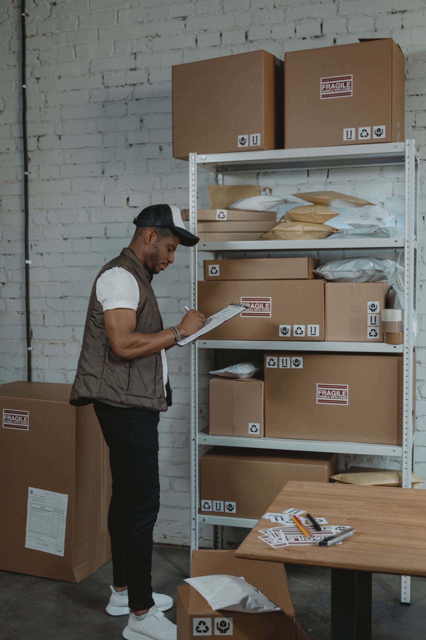 Worker checking order paperwork and delivery costs before shipping