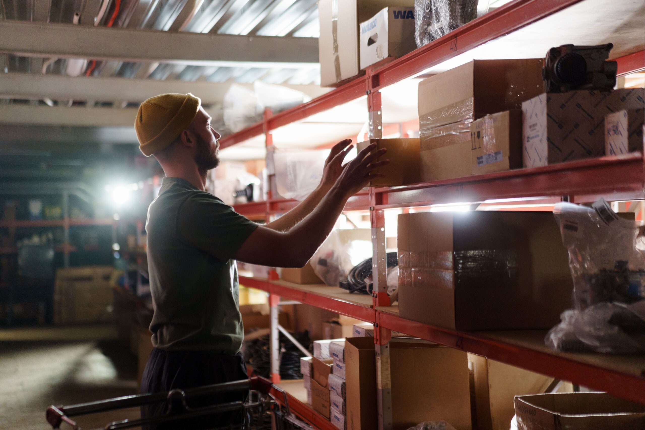 Worker checking inventory before committing to a stock purchase