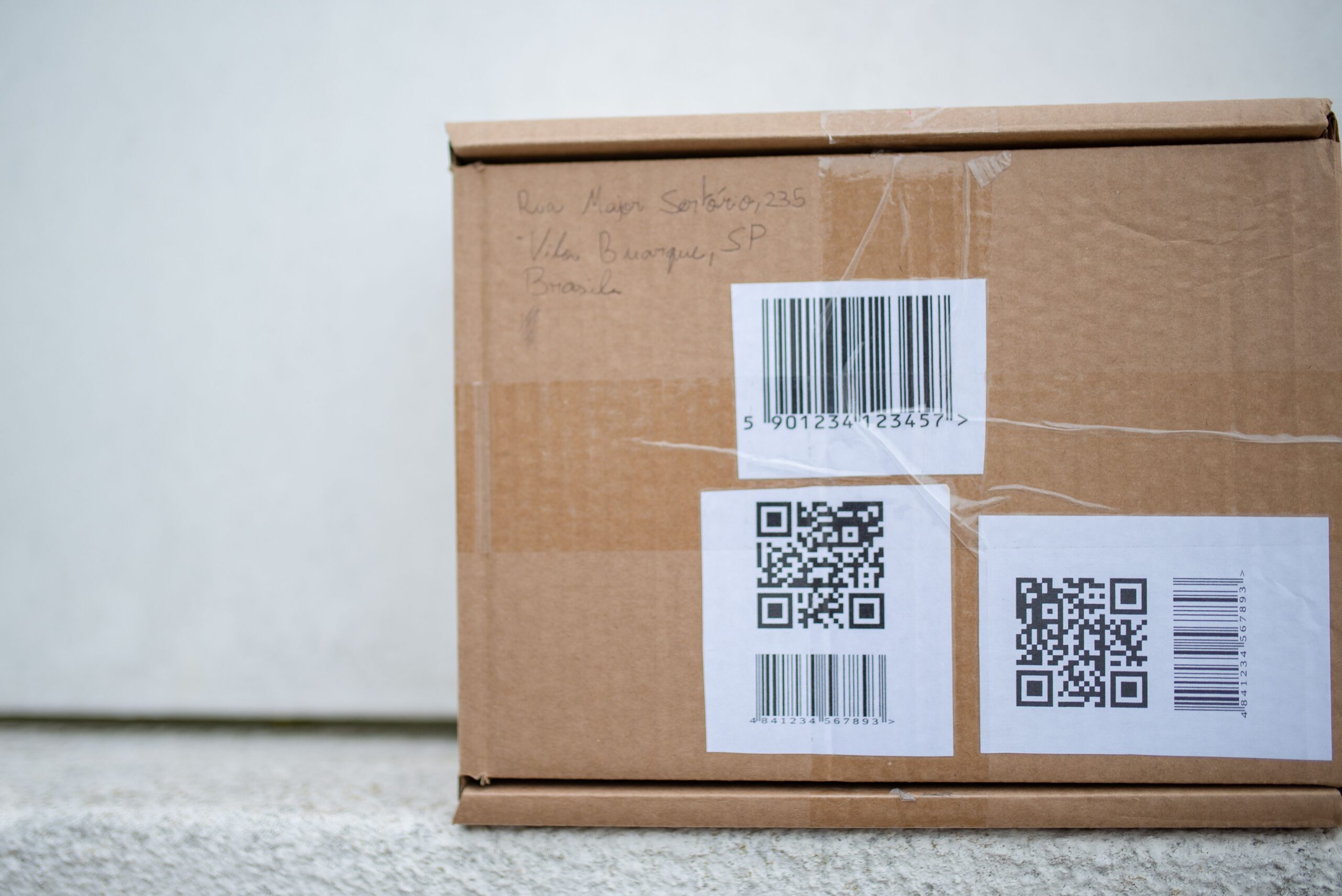 Shipping label barcode and tracking identifier on a package