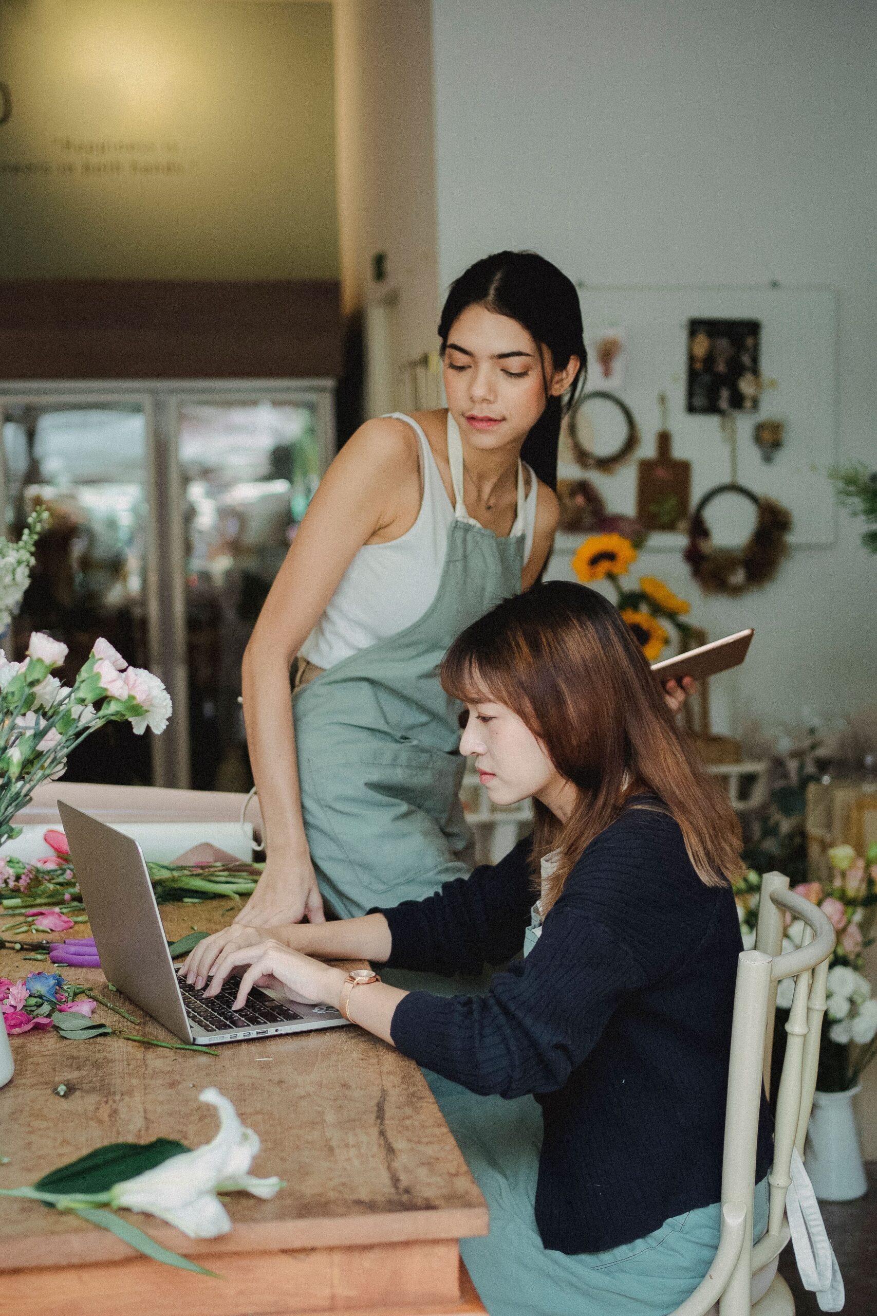 Small shop owners reviewing incoming online orders on a computer