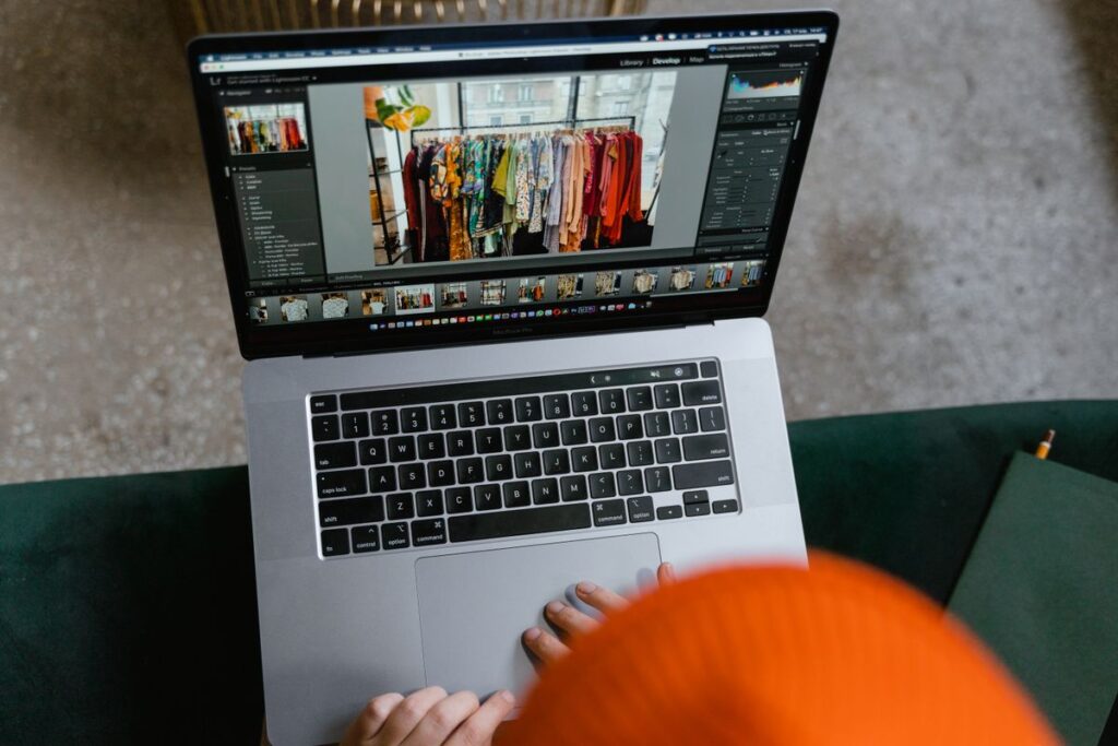 Person editing product page content and layout on a laptop